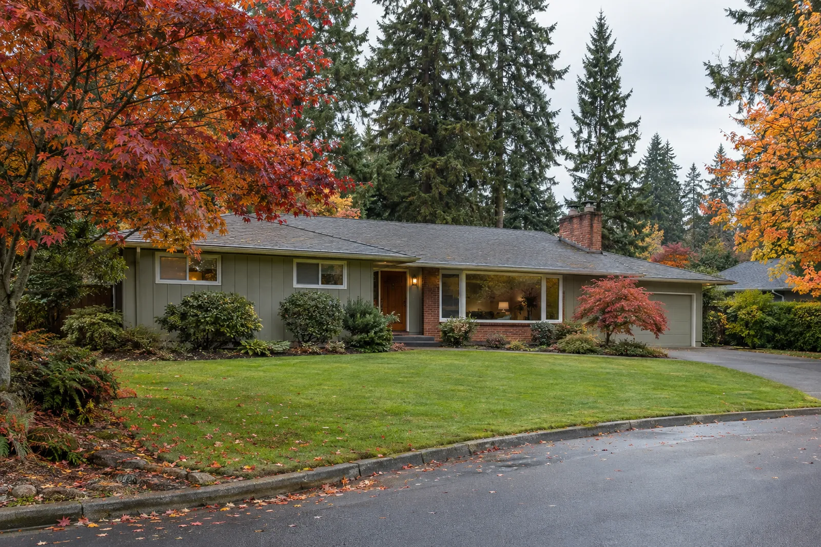 Single-level mid-century ranch home with a wide lawn on a quiet Cedar Hills, Oregon street in autumn