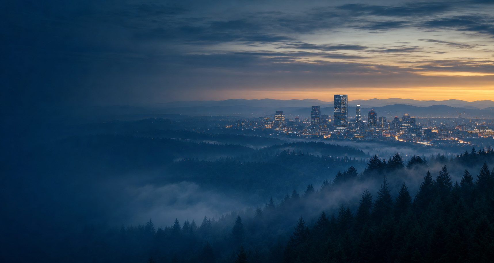 Portland metro skyline at blue hour framed by Douglas fir forest